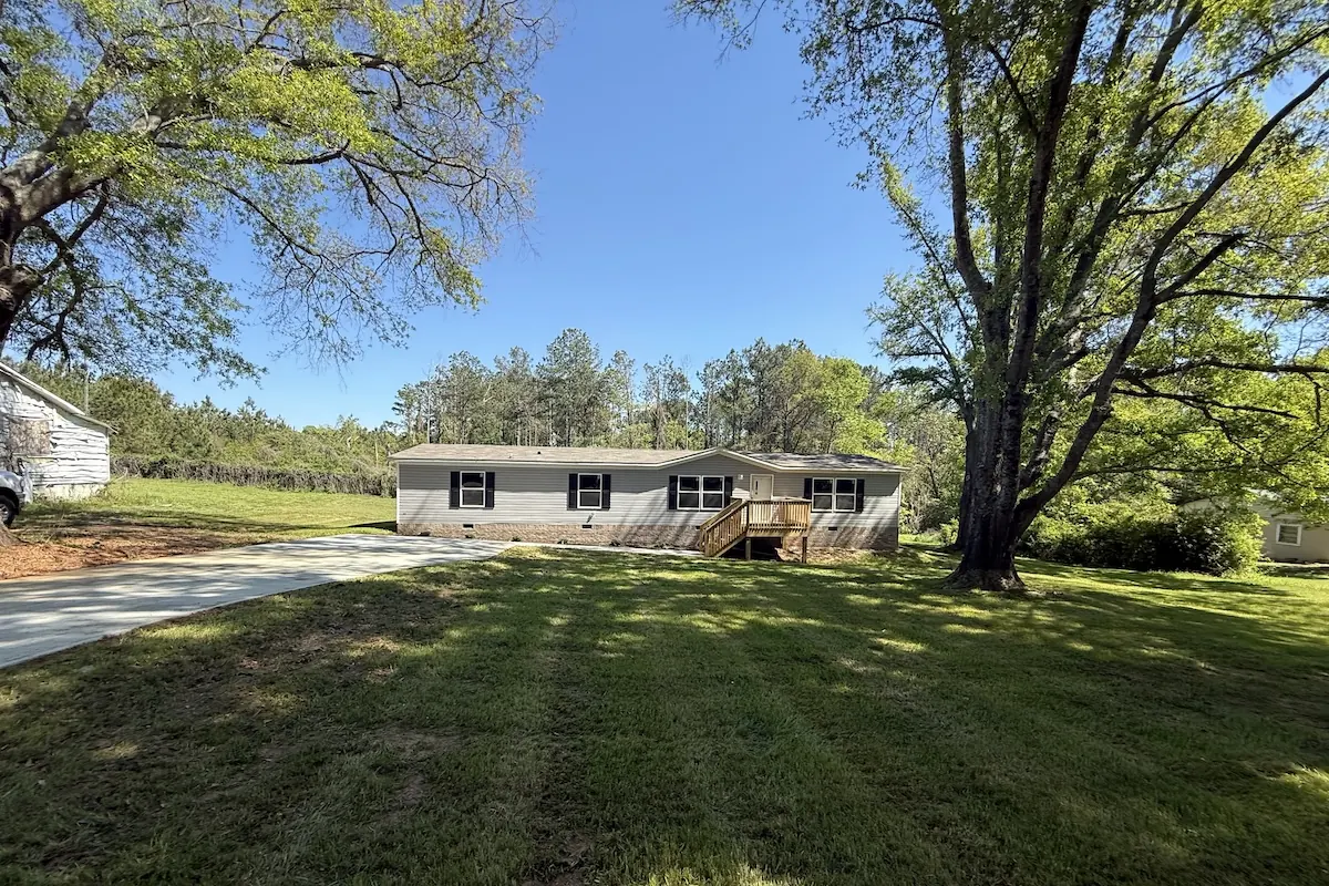 Finished mobile home leveled and set up on a cleared lot