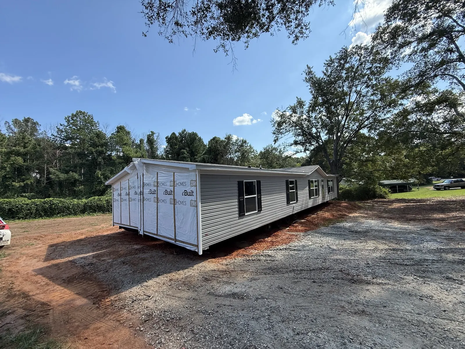 Single-wide mobile home set up and leveled on a prepared site