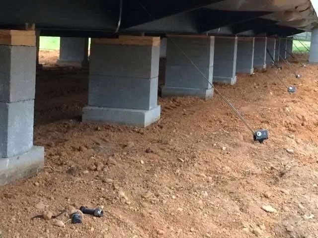 Concrete piers blocking and leveling a mobile home