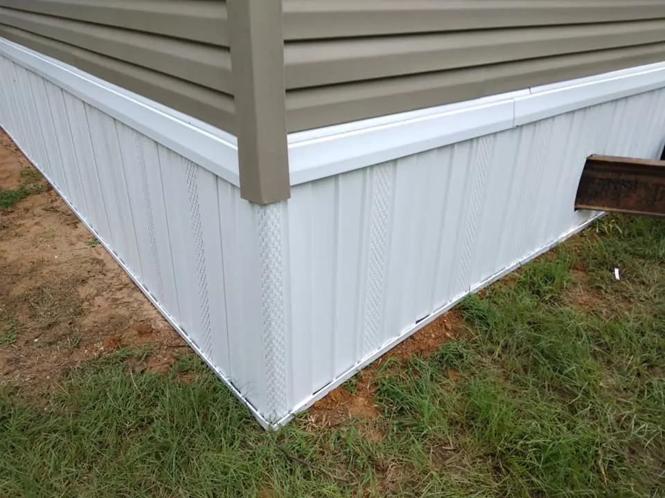 White vinyl skirting installed around a mobile home